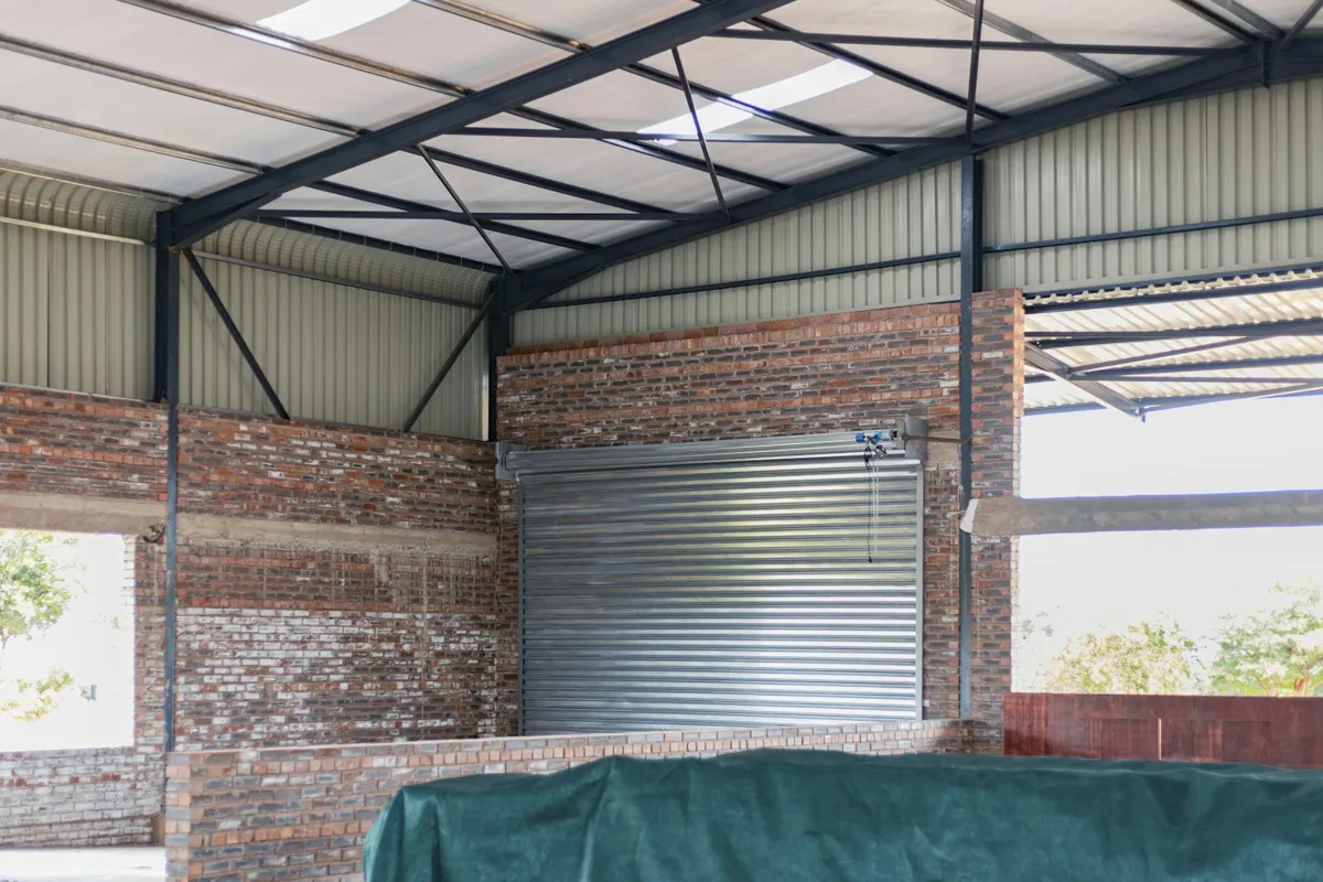Roll-up door under a steel roof structure