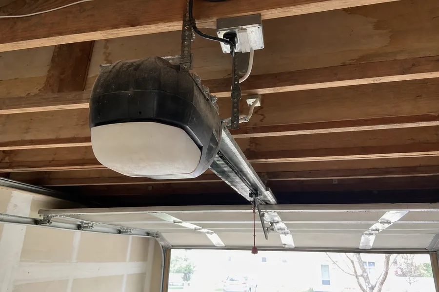 Opener rail and trolley above a single-car garage door