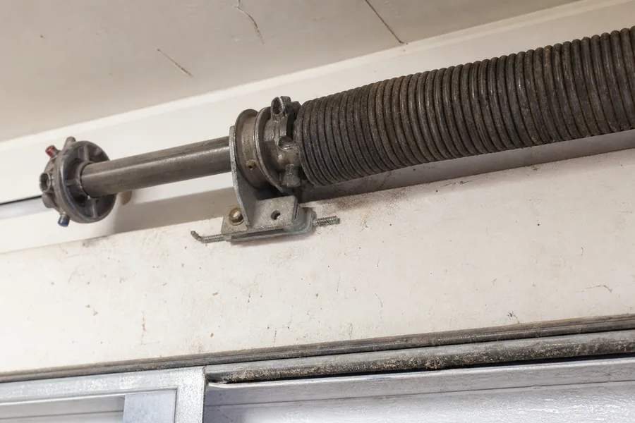 Torsion spring, winding cone and center bearing above a garage door in Wichita, KS
